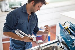 Plumber clearing a blocked drain